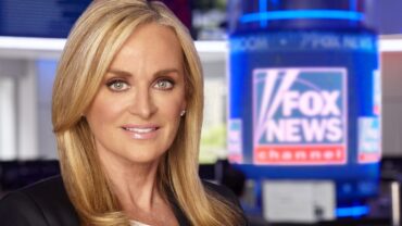 Suzanne-Scott-2018-in-newsroom.logo-in-focus.PRINT-2-scaled-e1608491003632